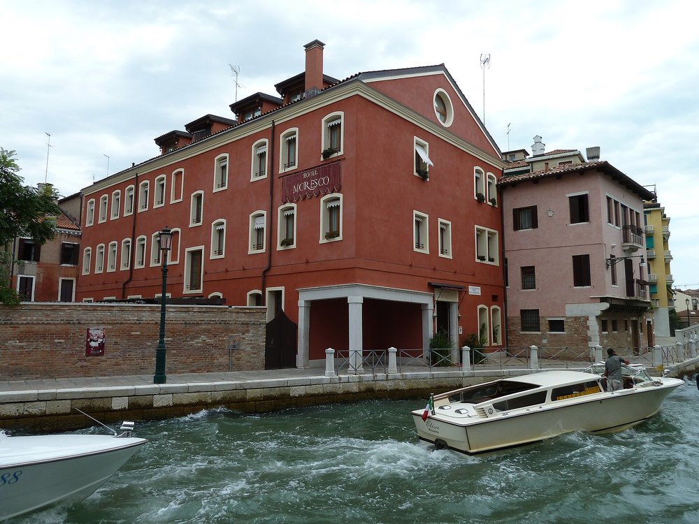 Hotel Moresco Venice exterior along a canal with water taxi passing