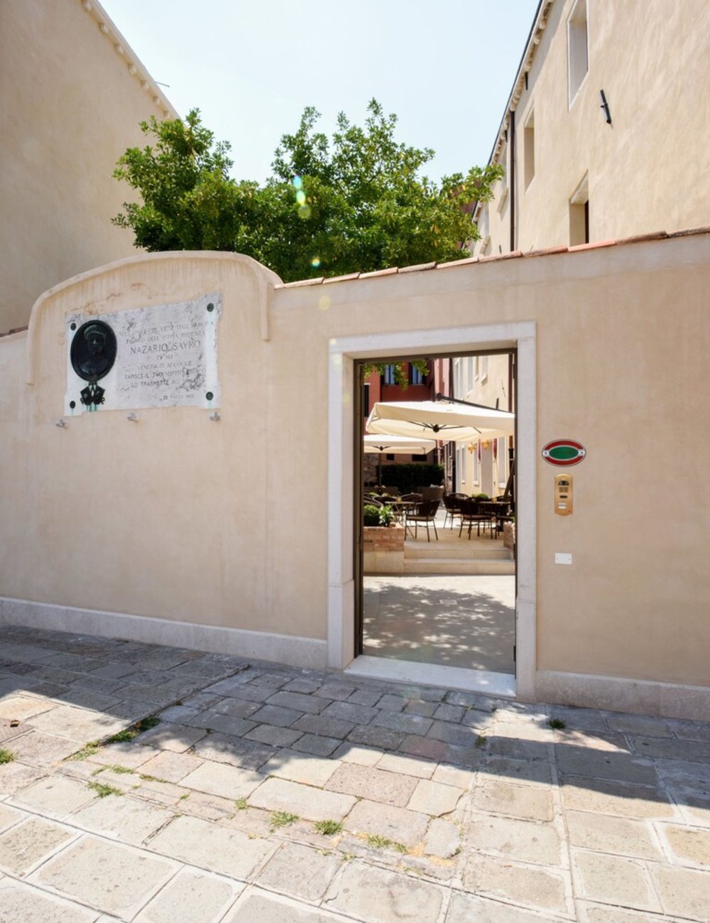 Santa Croce Boutique Hotel Boutique hotel courtyard in Venice with outdoor seating and warm tones
