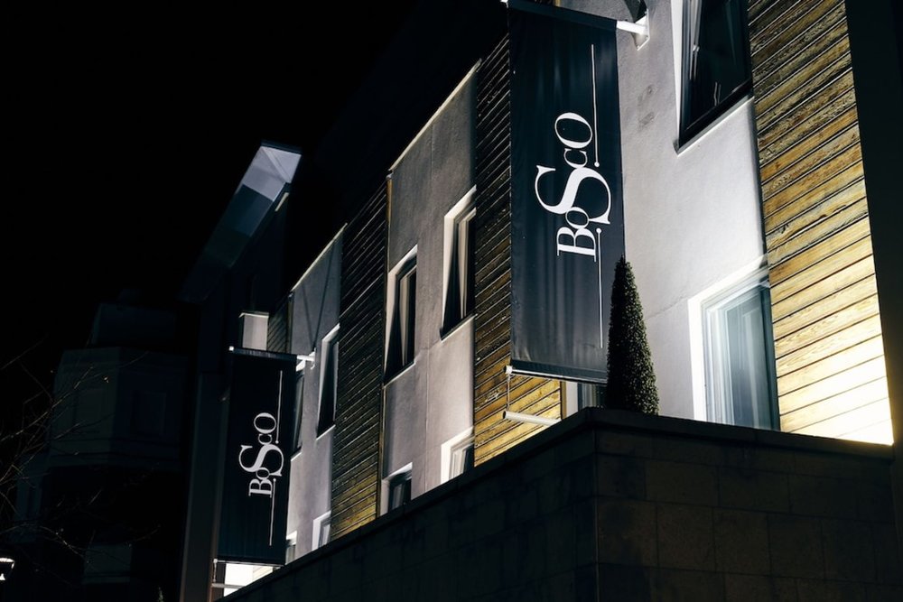 Hotel Bosco exterior at night showing modern design and signage in Surbiton, London