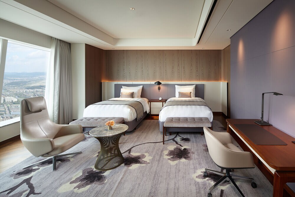 Signiel Seoul luxury hotel room with twin beds and modern interiors