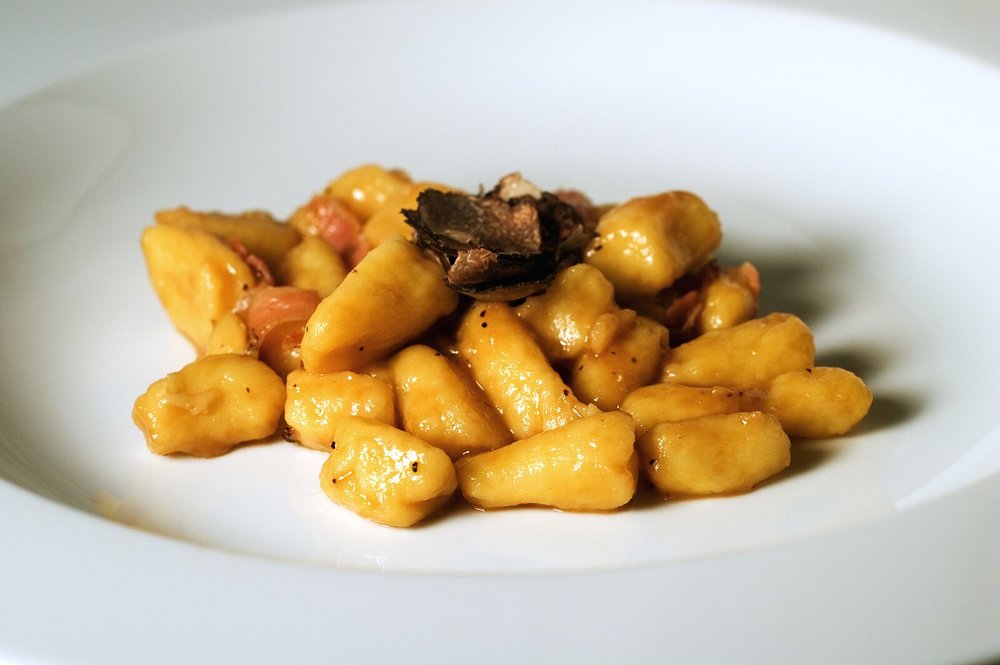 Gnocchi with truffle on a white plate