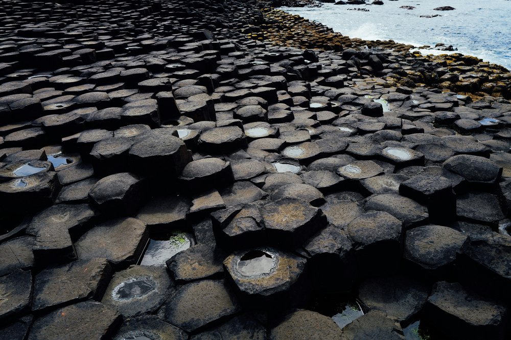 Hexagonal basalt rock formations at the Giant’s Causeway by the sea
