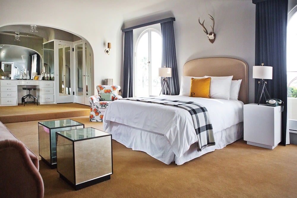 Elegant hotel suite in Los Angeles with modern decor and seating area