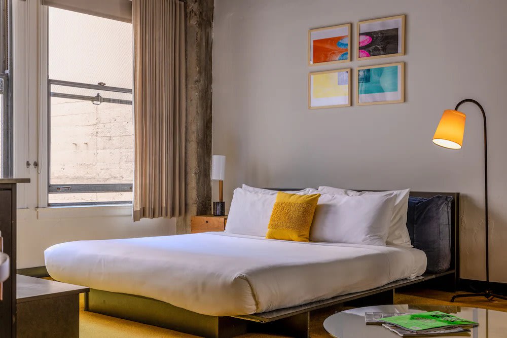Minimalist hotel room in Los Angeles with low bed and contemporary decor