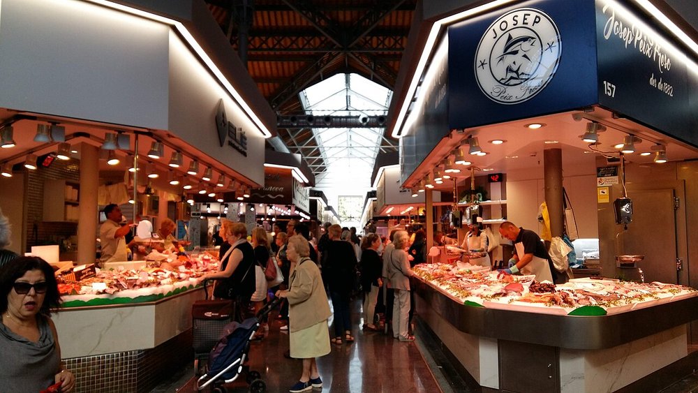 People shopping for food inside of Sant Antoni market