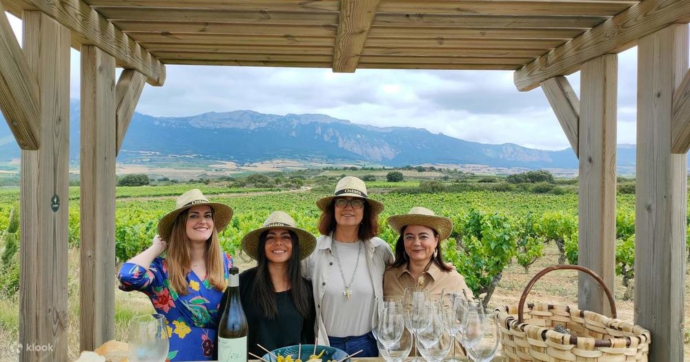 Four women pose before they enjoy their wine