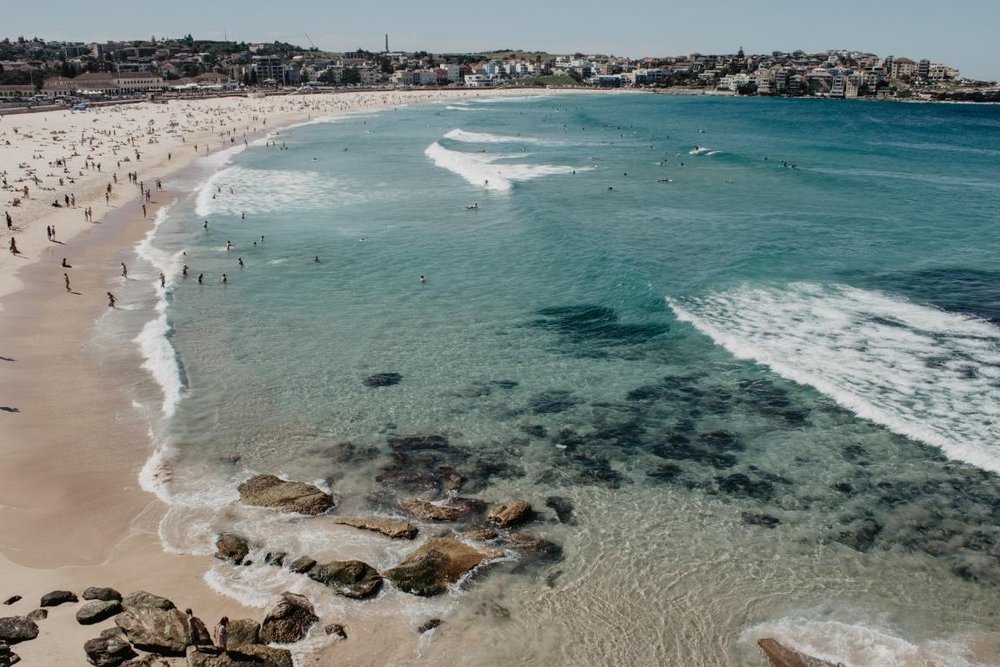 Aerial view of Bondi Beach with swimmers and coastal scenery in Sydney