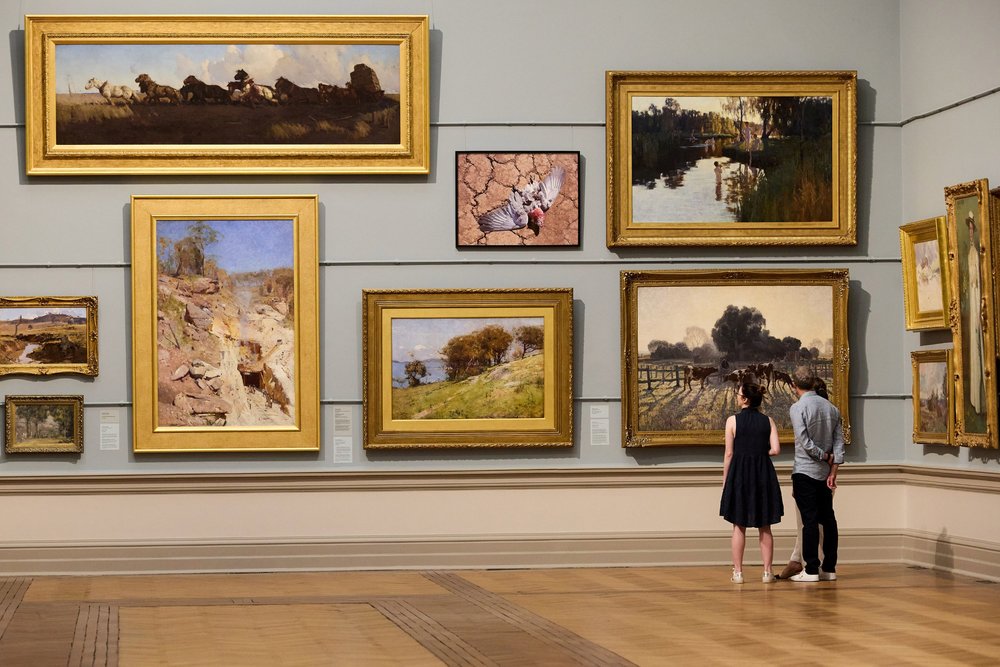 Visitors viewing paintings inside the Art Gallery of New South Wales