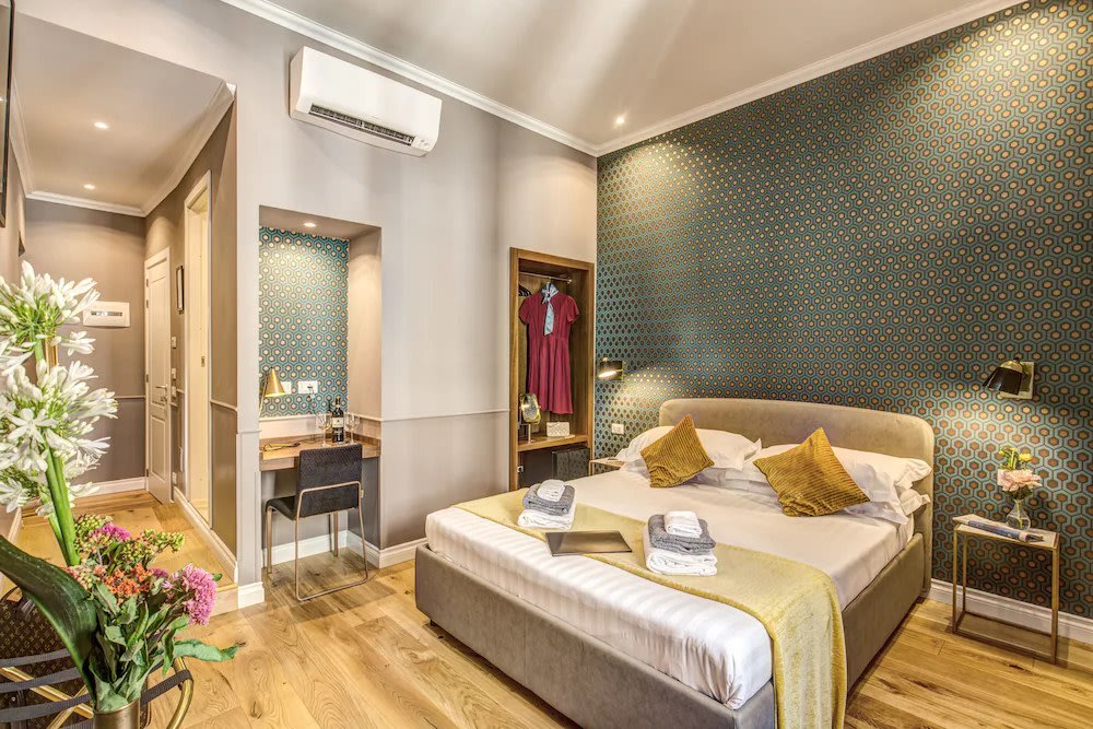 Comfort and style meet in a room at Charme Spagna Boutique Hotel.