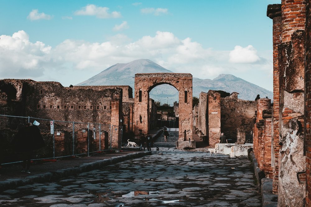 Pompeii ruins showing stone streets and Mount Vesuvius in southern Italy