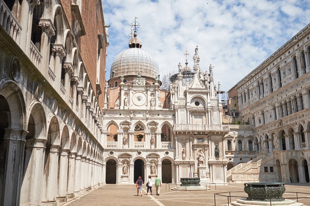 Doge’s Palace courtyard in Venice with ornate buildings and visitors