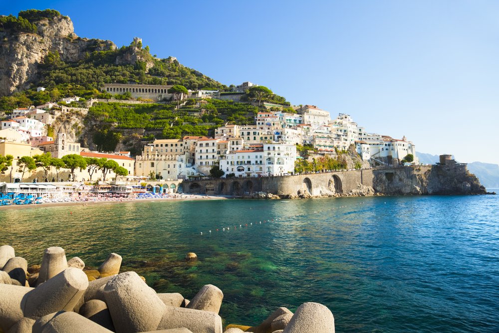 Amalfi Coast village with cliffside buildings and clear blue water