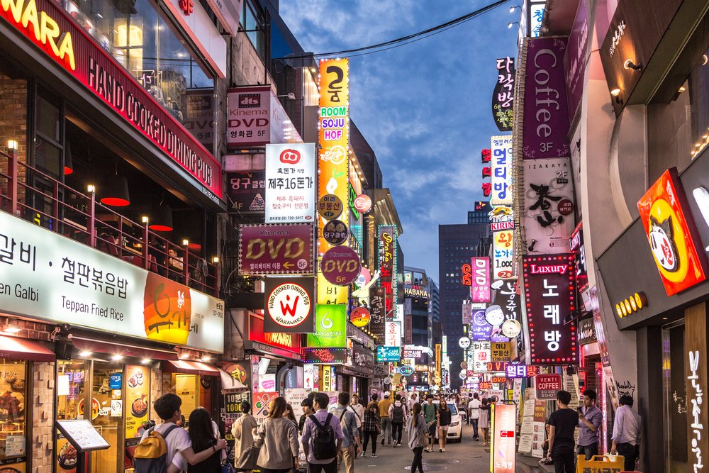 Busy Myeongdong street filled with shops restaurants and crowds in central Seoul