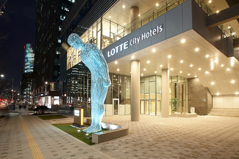 Lotte City Hotel Myeongdong exterior at night with city lights in downtown Seoul