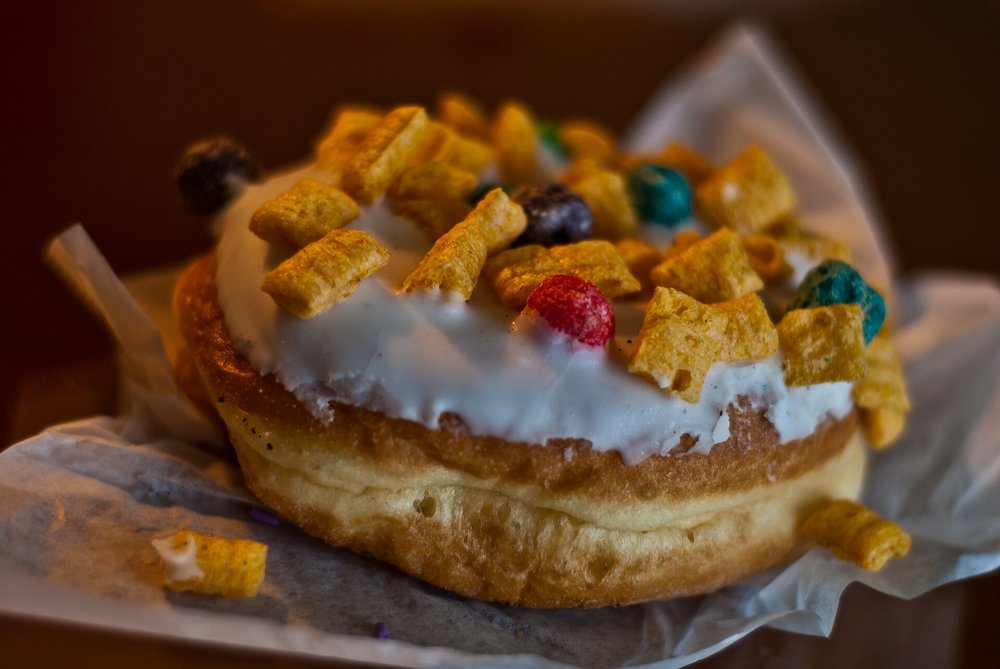 Glazed donut topped with crunchy cereal from a dessert shop in Orlando