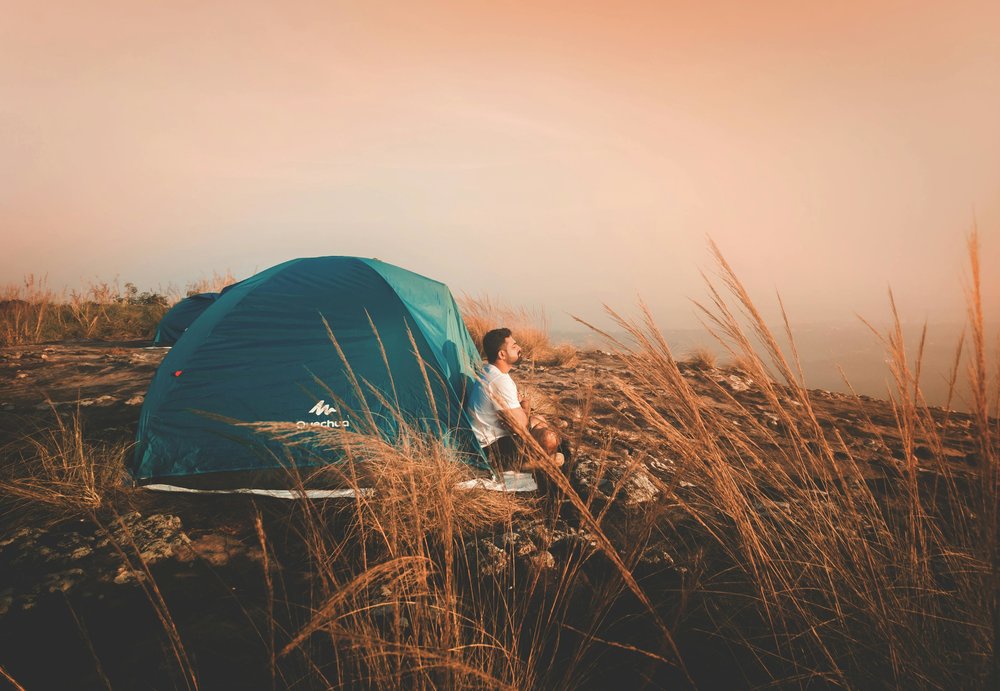 Solo traveler enjoying quiet camping alone in nature, recharging and reflecting in a peaceful setting | Photo from Bazil Elias on Pexels