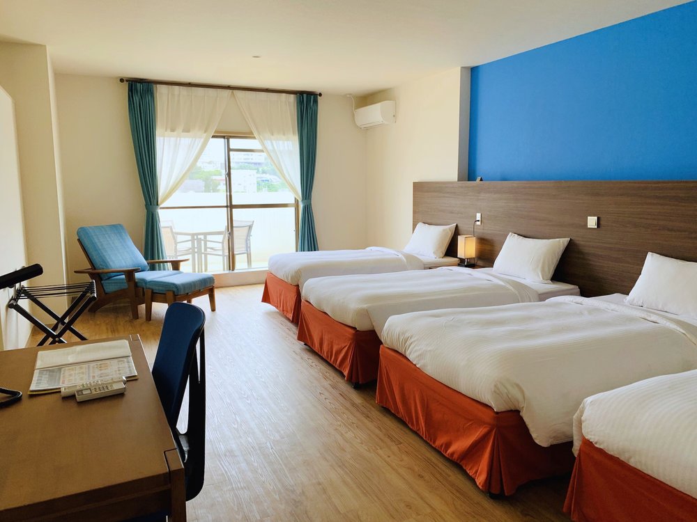 Bright triple room interior at Rycom Family Resort Hotel Okinawa