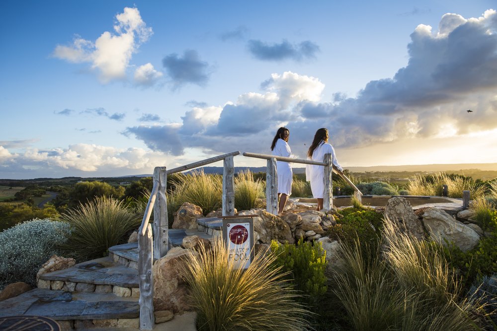 Tourists enjoying hilltop views at sunrise