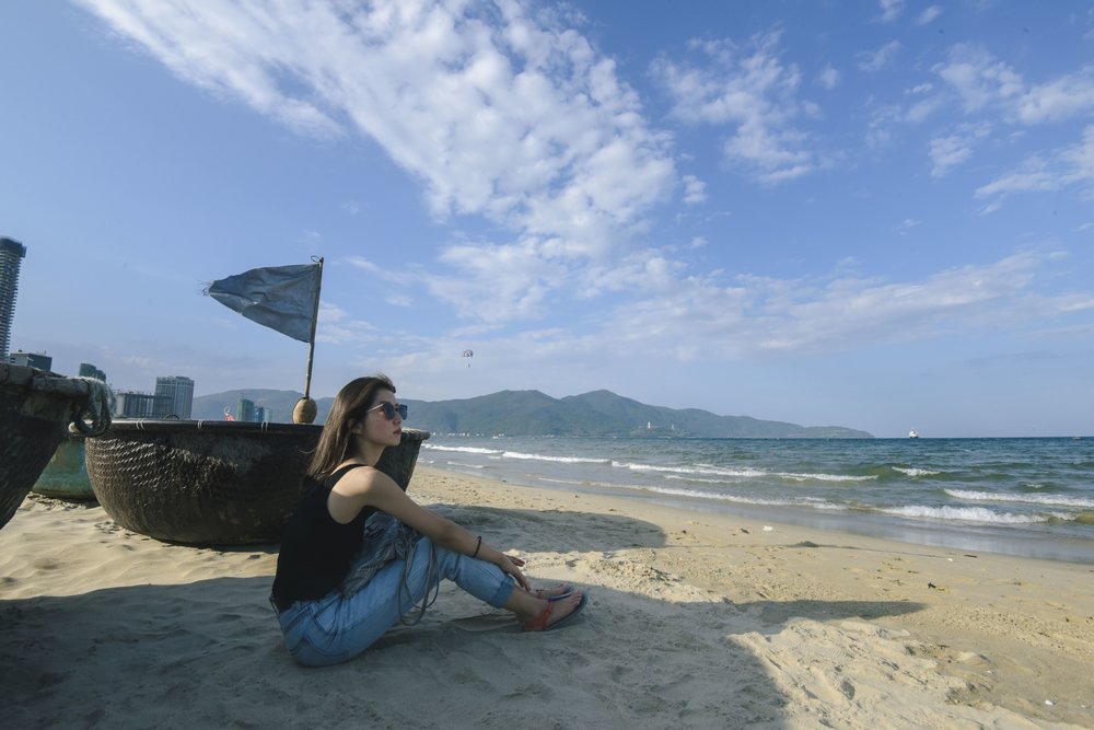 Traveler enjoying My Khe Beach Vietnam with calm waves and sandy shoreline