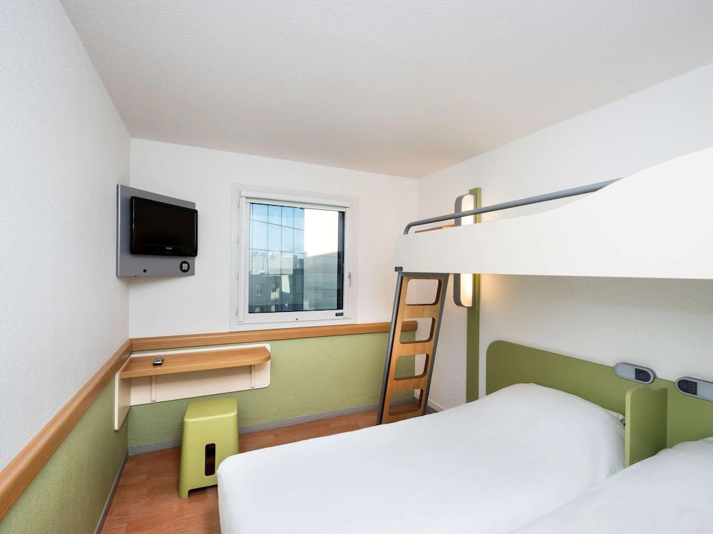  Simple hotel room with bunk bed and minimalist design