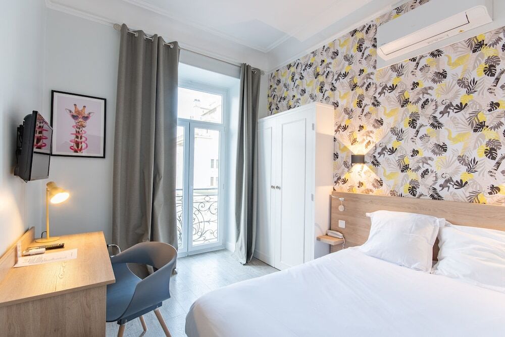  Stylish hotel room with floral wallpaper and balcony window