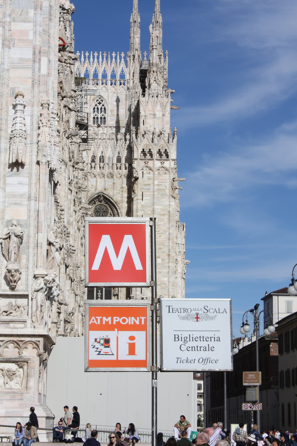 A metro stop signage with an ATM point signage below