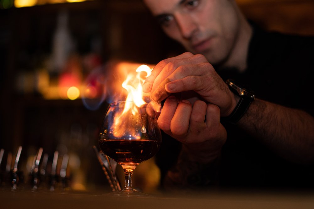 Close-up of bartender making a smoked cocktail at a Melbourne cocktail bar