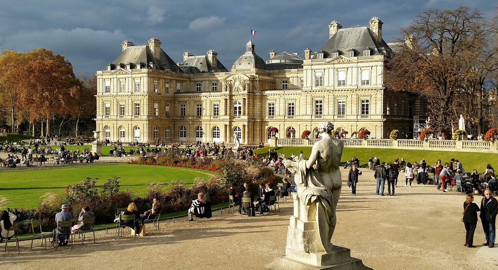 People enjoying a sunny day at Luxembourg Gardens in Paris