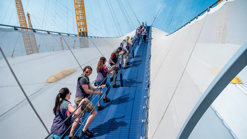 People climbing the roof walkway during the Up at The O2 experience in London