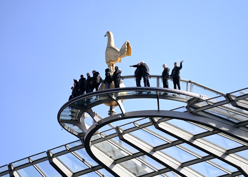 People standing on the Dare Skywalk above Tottenham Hotspur Stadium in London