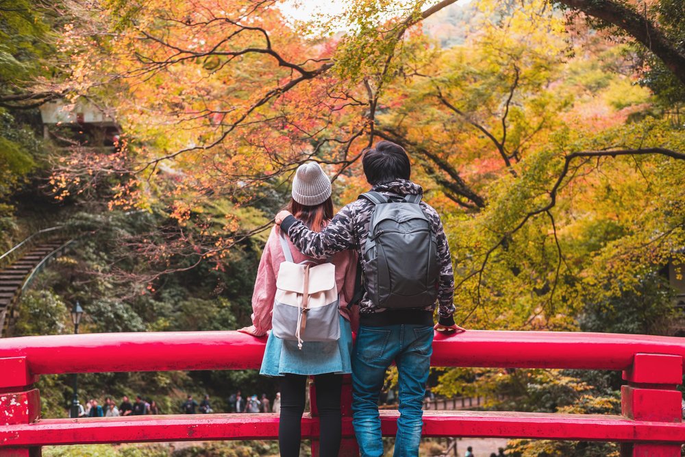 Couple enjoying fall foliage at Minoo Park near Osaka waterfall trail