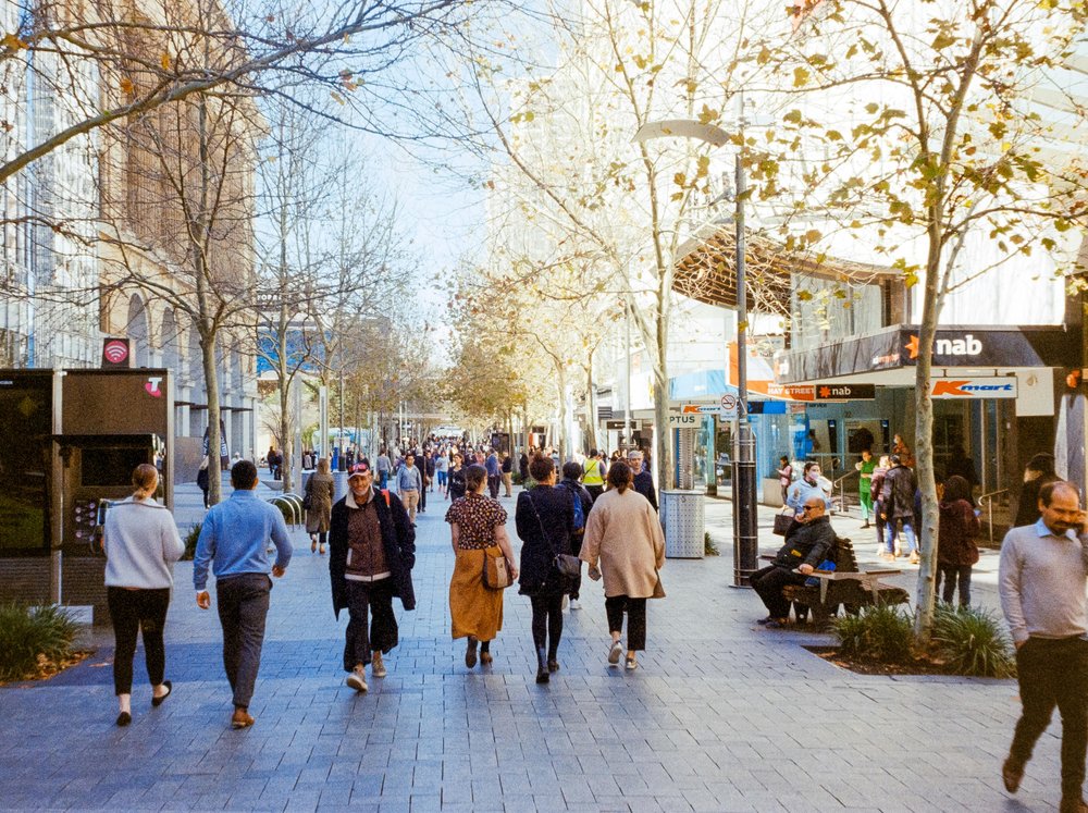 Crowds walking along a popular shopping street in Sydney city