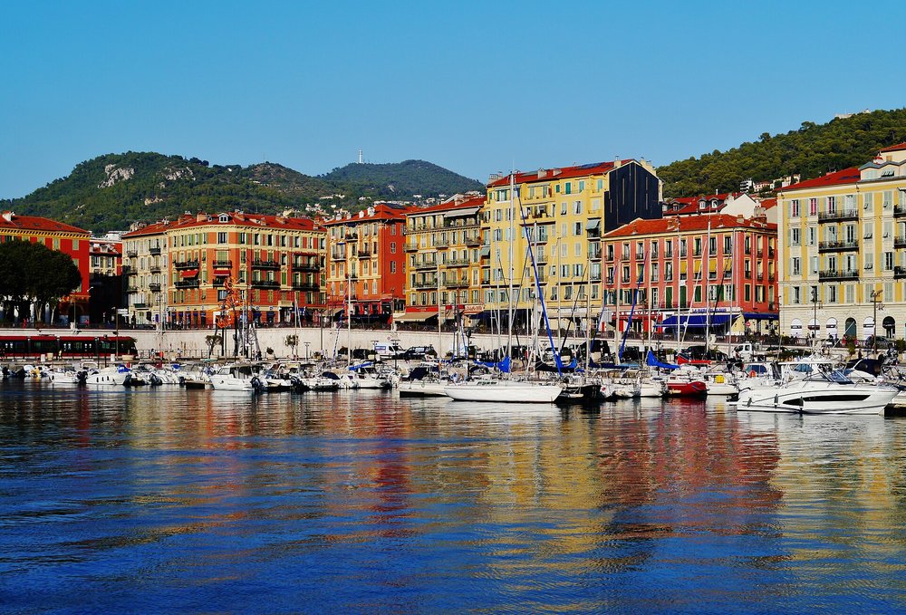 Harbor view of Port Lympia with yachts and colorful buildings in Nice
