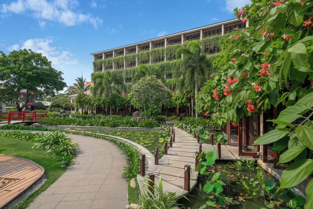 Silk Sense Hoi An River Resort with garden walkways and lotus pond