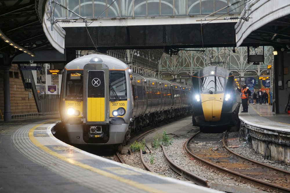Heathrow Express trains at a London station platform under a railway terminal | Photo Credit: omegamezle on Unsplash