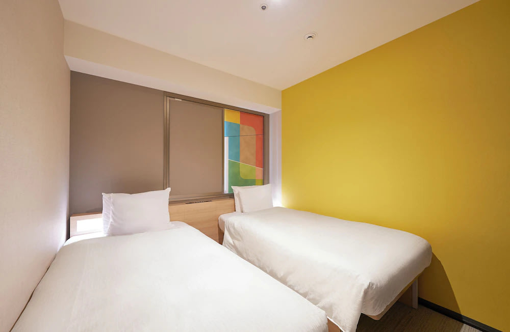 Budget-friendly Osaka hotel room with twin beds and modern design