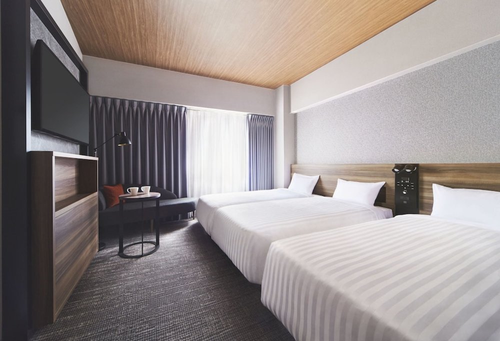 Contemporary hotel room in Osaka with clean design and comfortable beds