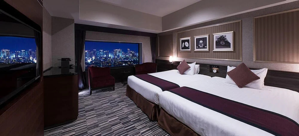Osaka hotel room with nighttime city views and modern interior design