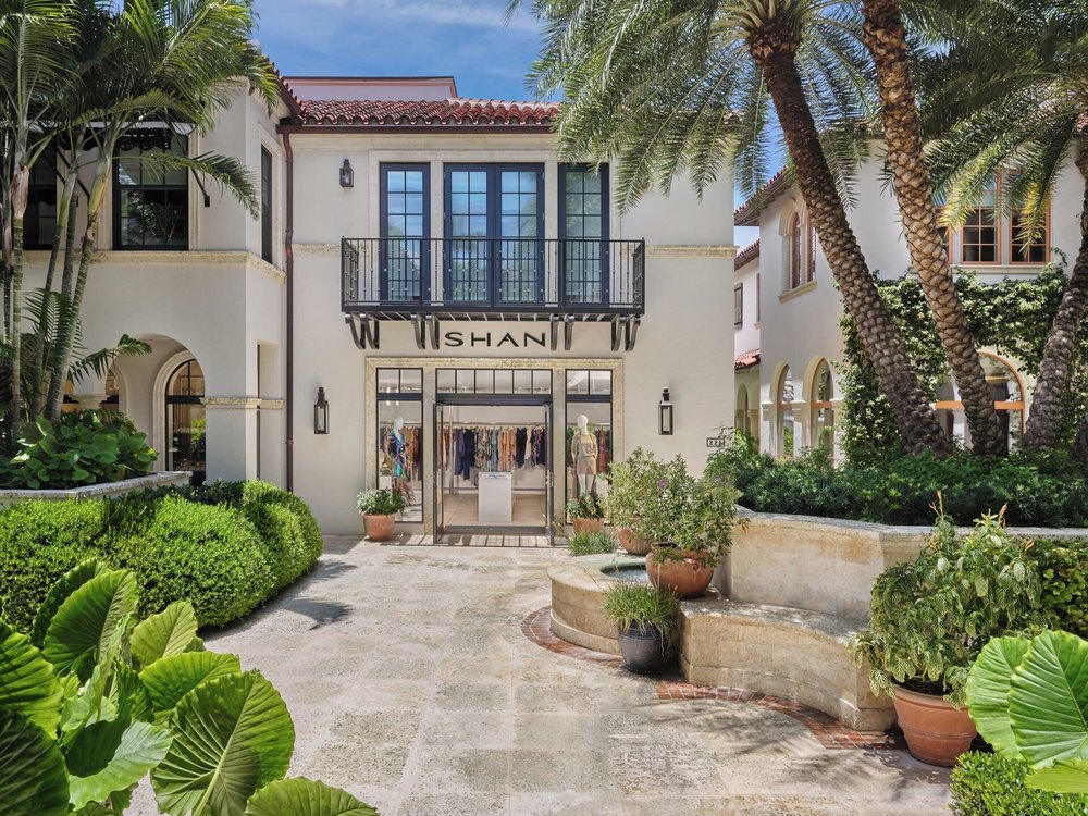 Elegant resort boutique with palm trees and Spanish-style design in a luxury US resort