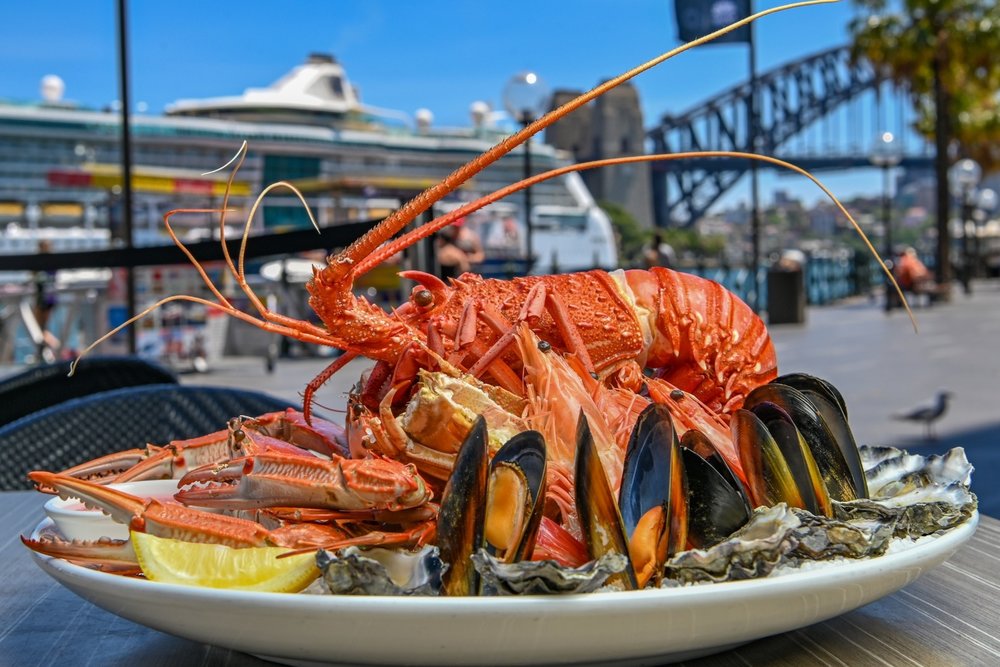 Seafood platter with lobster, oysters, and mussels near Sydney Harbour Bridge