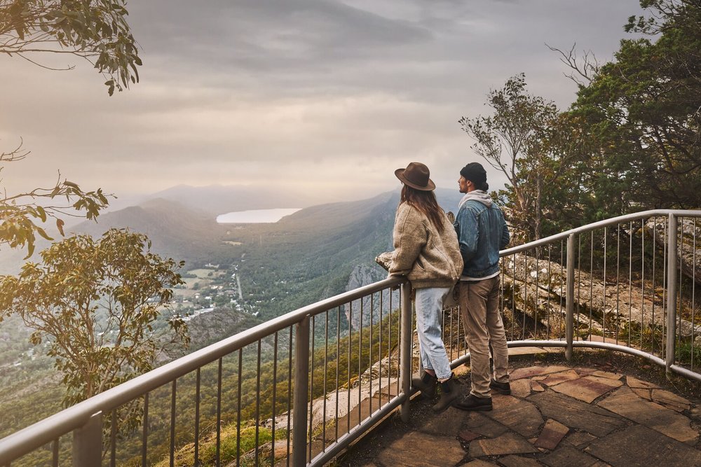 Couple standing at a lookout with sweeping mountain views in the Grampians