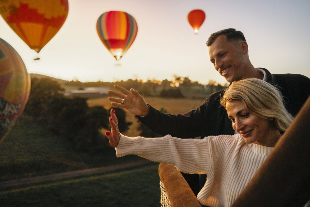 Couple enjoying a sunrise hot air balloon flight over Yarra Valley