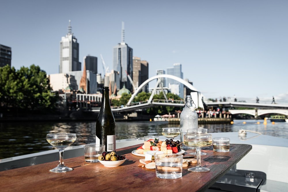 Picnic table with drinks on a private electric boat on the Yarra River