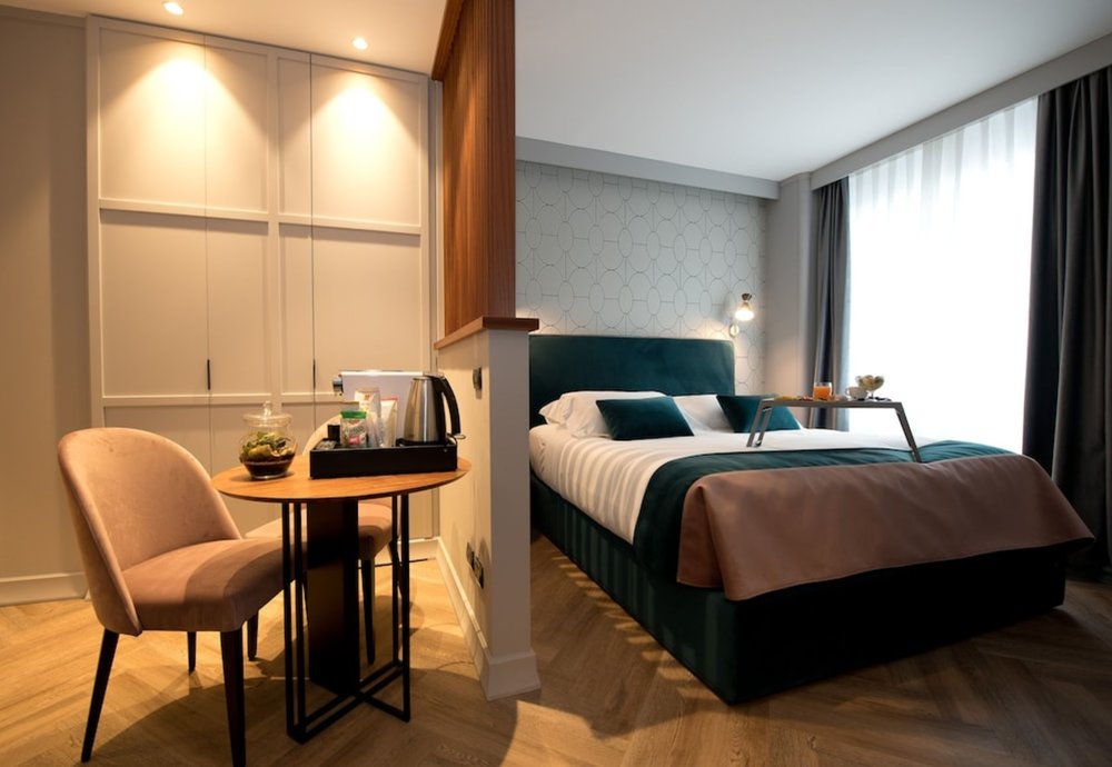 Contemporary hotel room in Milan with minimalist design and city light