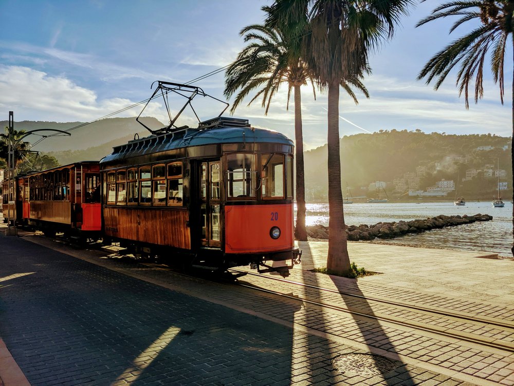 Scenic commuter train traveling along a coastal route in Spain | Photo Credit: Wojciech Then on Unsplash