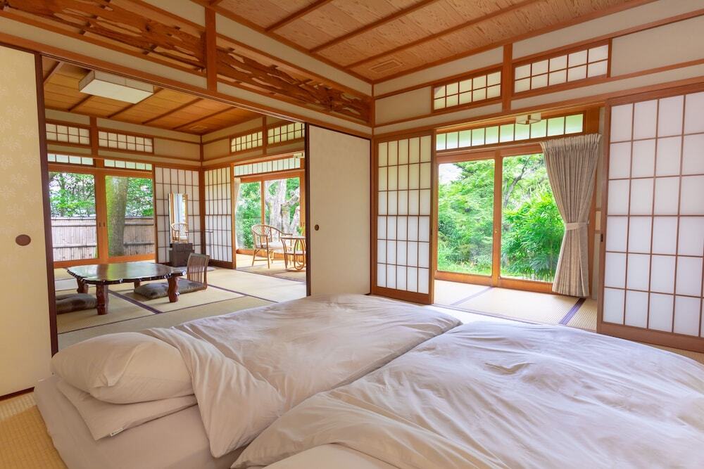 Japanese ryokan room at Yoshida Sanso Kyoto with tatami floors and futon beds
