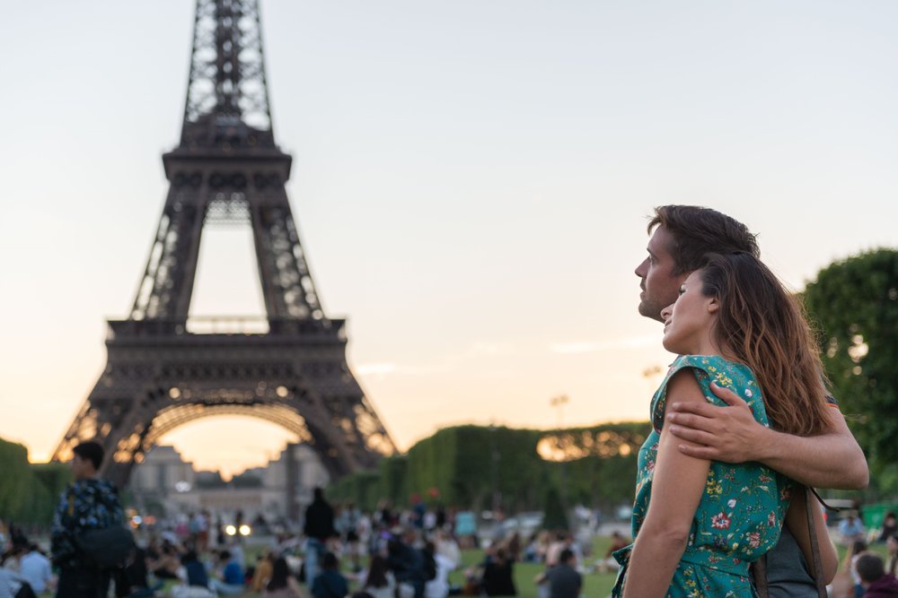 Couple enjoying a sightseeing moment near the Eiffel Tower in Paris during spring