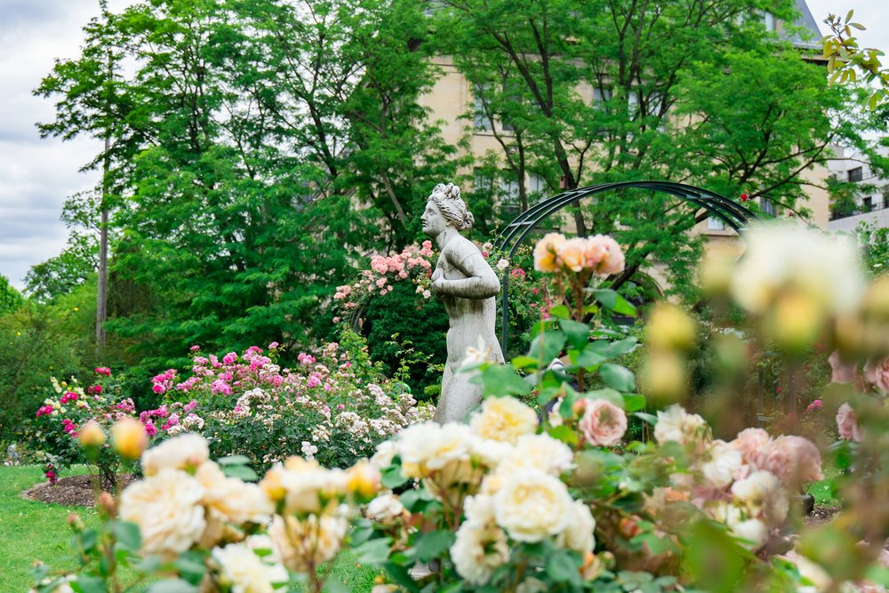 Classic sculpture set in the roses of the Jardin des Plantes in Paris