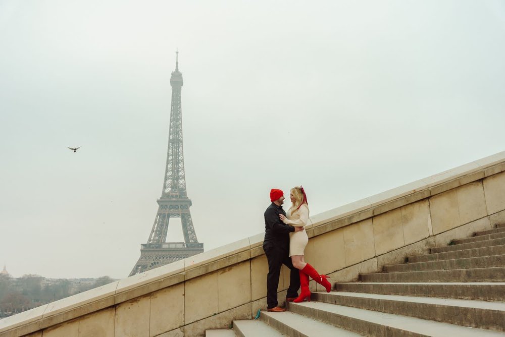 Couple posing for a private photoshoot with the Eiffel Tower in the background in Paris