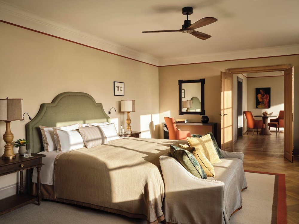 Sunlit guest room at Collegio alla Querce with warm, refined decor